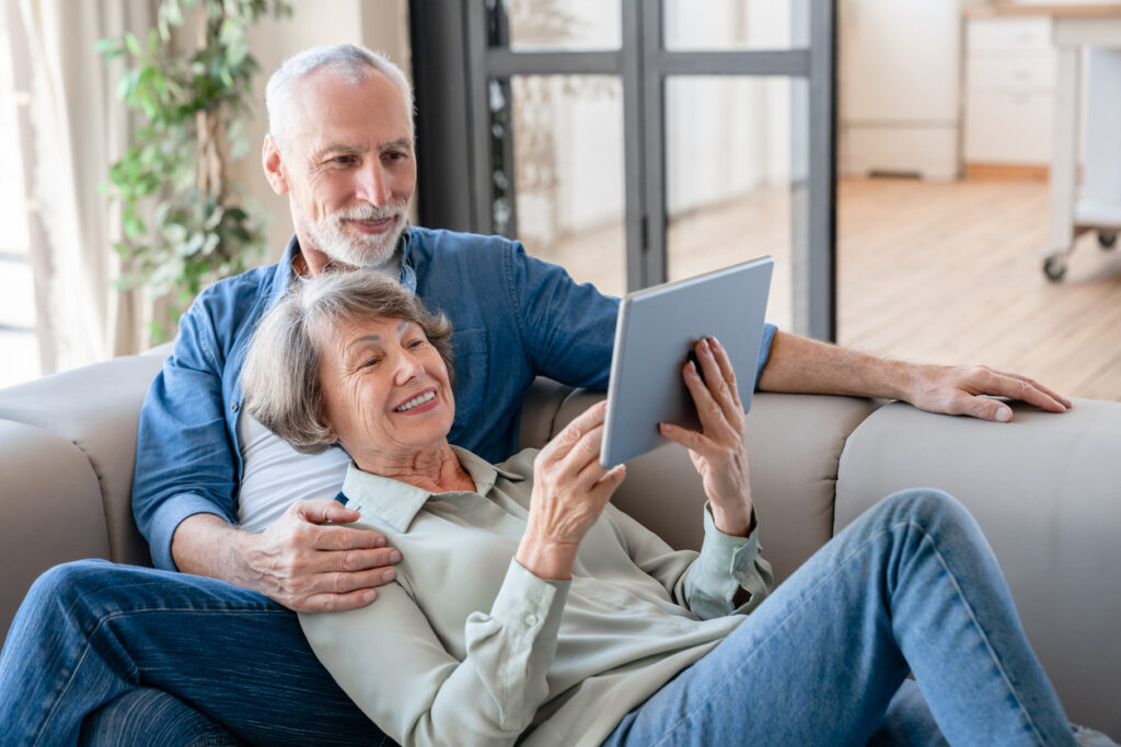 Relaxed cheerful senior couple watching tablet at home together, How Environmental Toxins Affect Longevity: Learn How to Minimize Your Risks