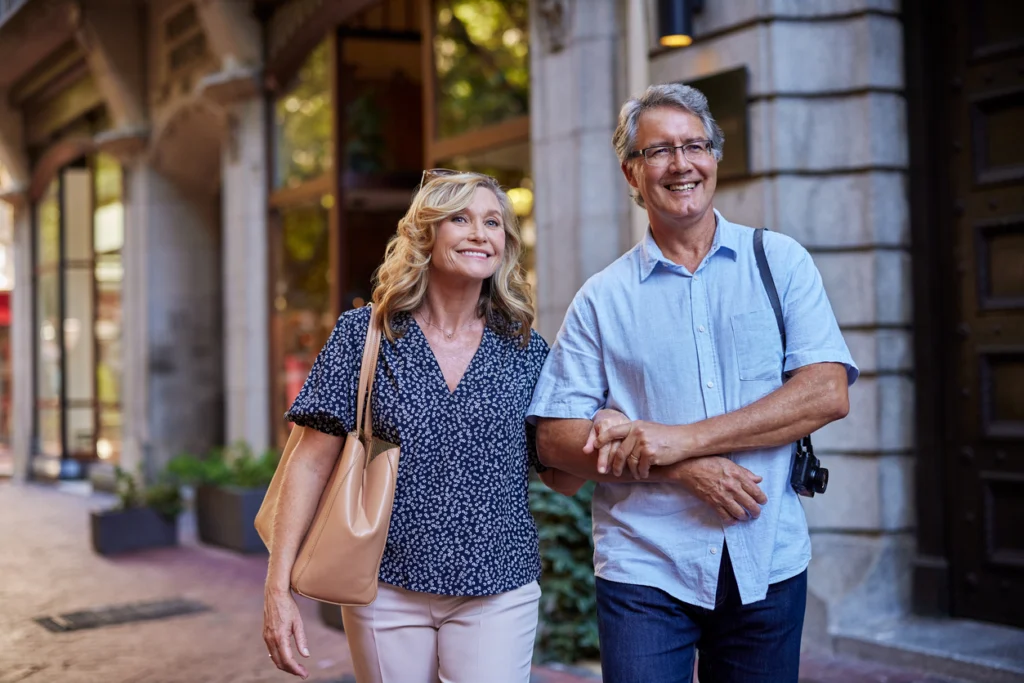 Active older couple walking together outdoors, representing staying healthy as you age