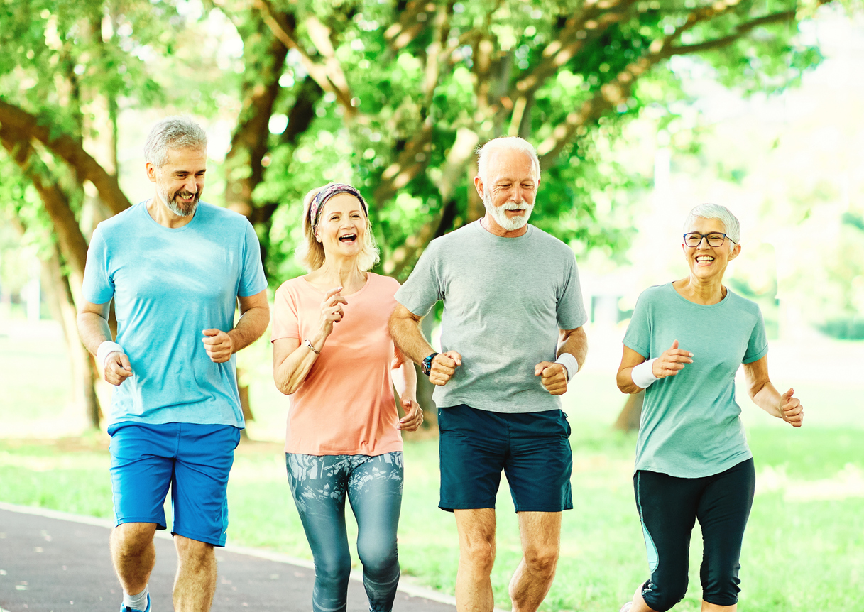 Active older adults jogging outdoors together to support muscle health, mobility, and healthy aging.