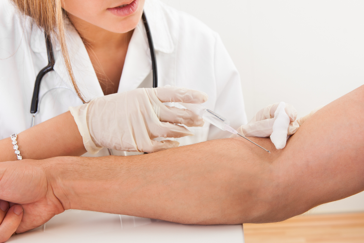 Healthcare professional drawing blood for laboratory testing