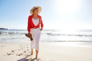 Healthy older woman walking along the beach